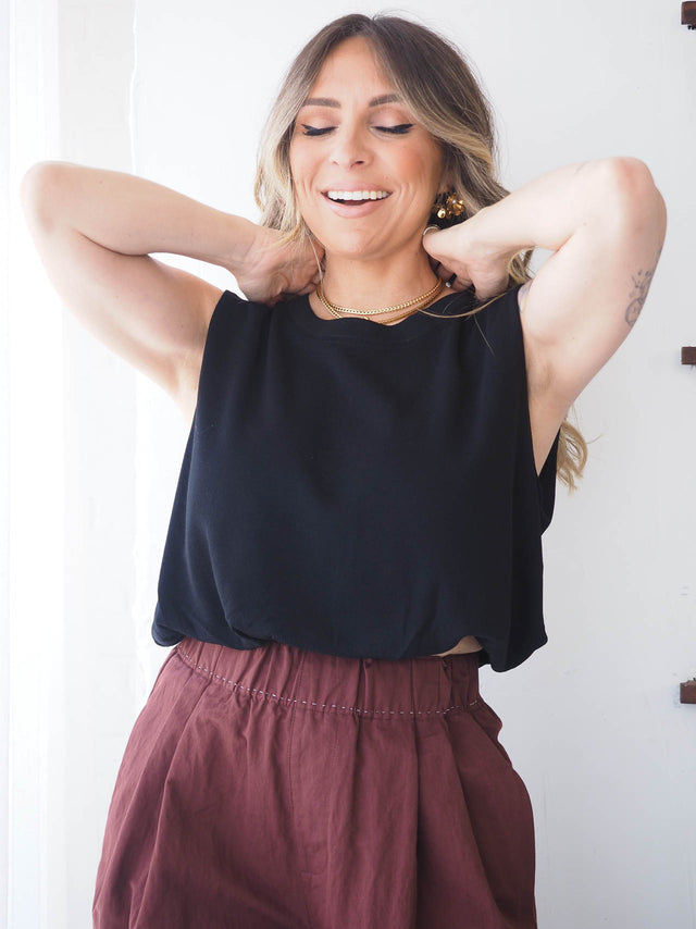 Top de malha fresca feminina em preto com gola redonda, ideal para looks casuais de primavera e verão.