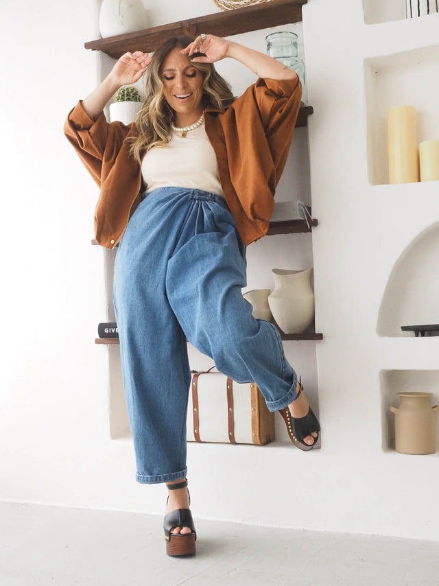 Modelo feminina sorridente a usar calças baggy balloon com blazer oversize, ideal para estilo descontraído e elegante.