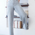 Modelo usando calças de ganga palazzo cinzas com cintura alta, destacando conforto e estilo.
