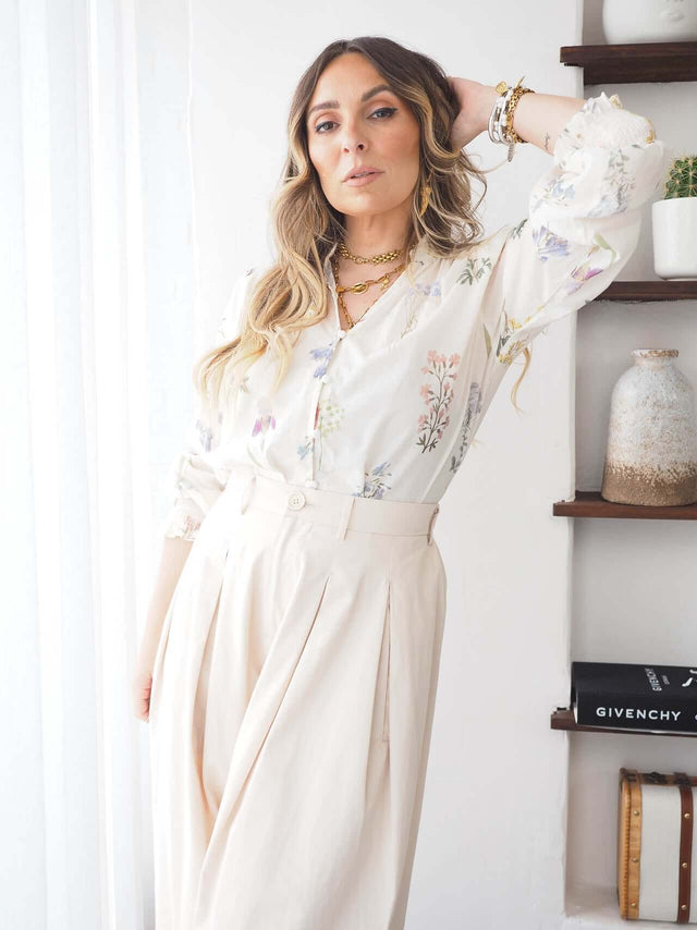 Modelo feminina usando blusa estampada romântica com folhas, perfeita para looks casuais chic.