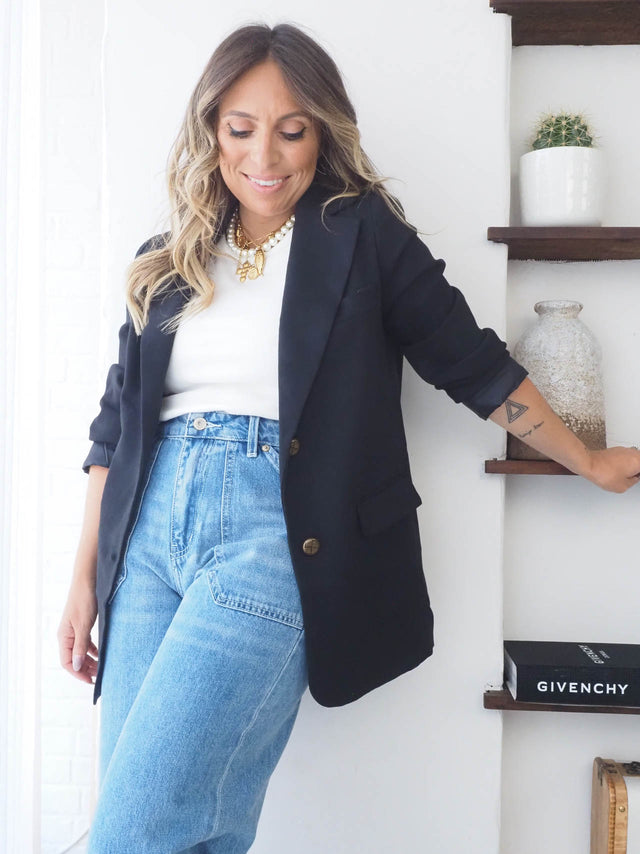 Mulher à moda com blazer feminino elegante, calças jeans cintura alta e acessórios, ideal para primavera/verão.
