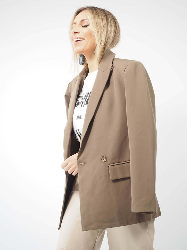 Este blazer liso, com forro, apresenta um colarinho de lapela, fecho de botões e bolsos frontais.