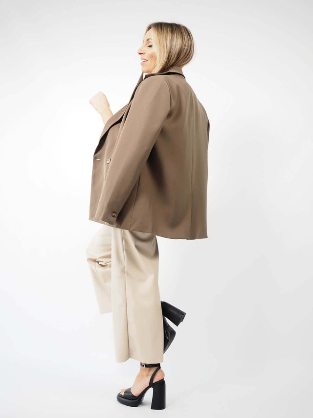 Blazer liso de manga comprida com pormenor visto de lado.