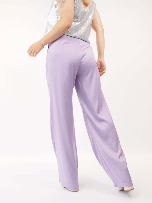 Calças pantalonas em cetim de cor lilás sem bolsos na parte de trás, confortaveis, fazem uma silhueta bonita e elegante.